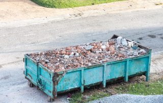 Garbage roro dumpter bin collects rubbish at construction site